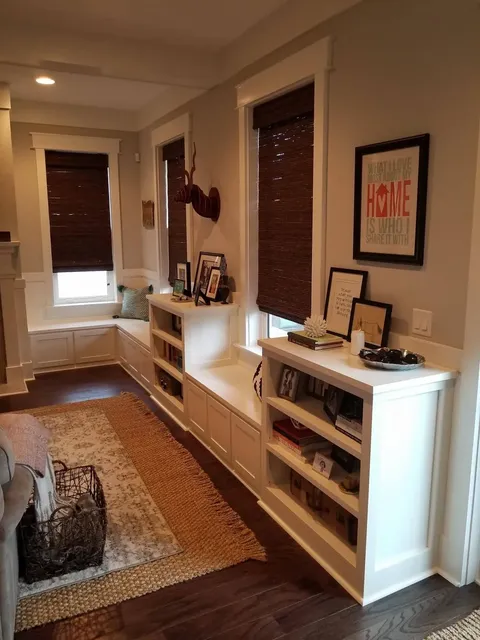 White mudroom with built-in benches, shelving and brown wood accents