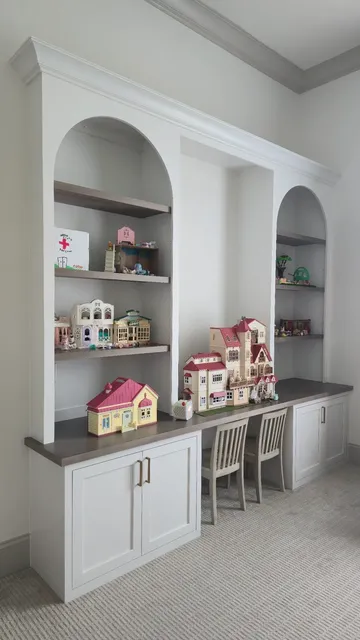 White desk unit with arched alcoves, gray shelves and lower cabinetry