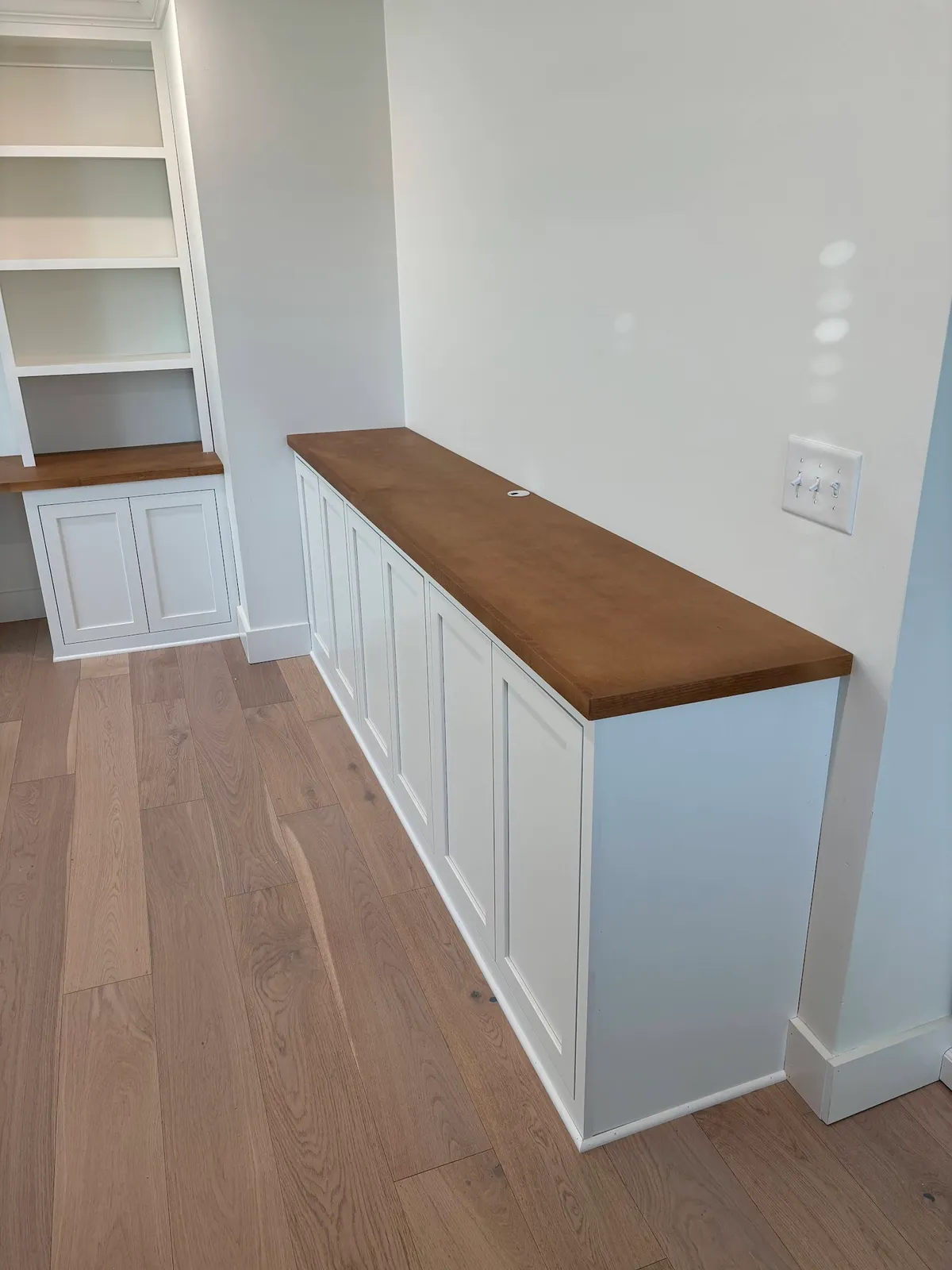 White cabinetry with walnut countertop and open shelving detail