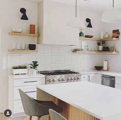 Modern white kitchen with subway tile backsplash and floating oak shelves