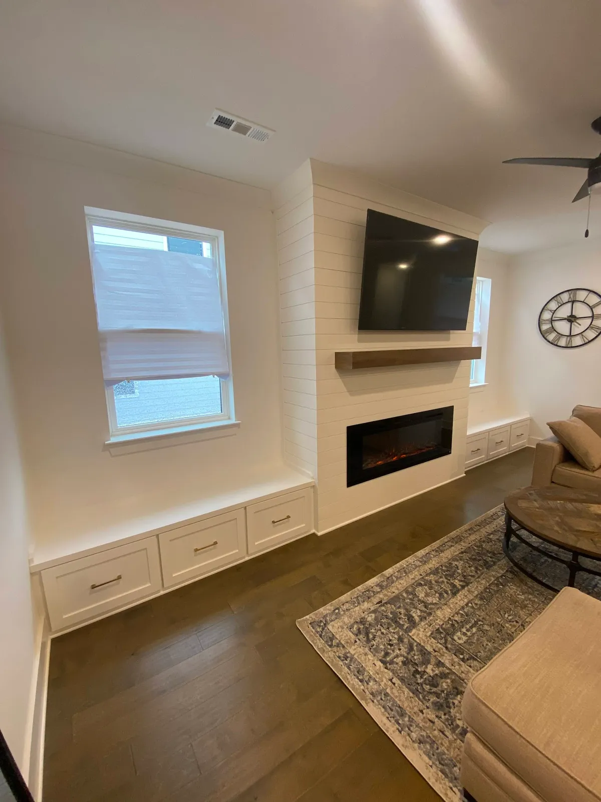 Modern fireplace wall with shiplap surround, shelving, and electric insert