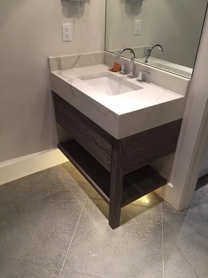 Modern bathroom vanity with dark wood base and white double-sink countertop