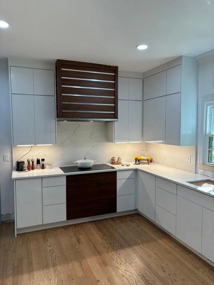Light gray shaker kitchen with custom wood range hood detail