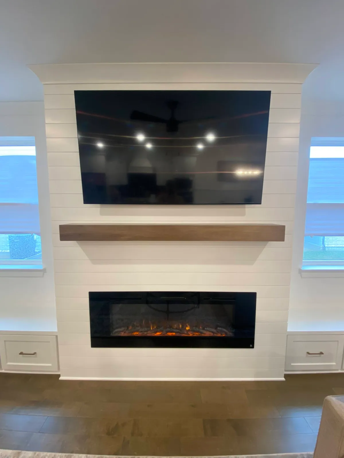 White fireplace wall with stacked shiplap and electric insert