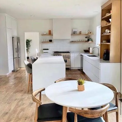 White modern kitchen with open shelving and wood dining table