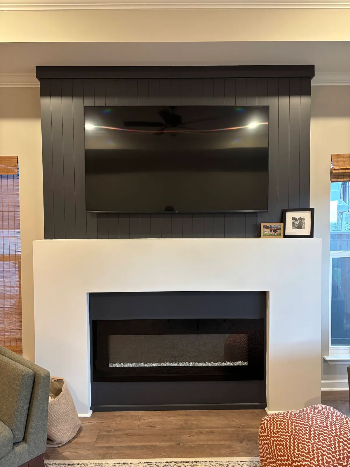 Entertainment wall with dark gray vertical shiplap and electric fireplace