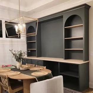 Gray media nook with open shelving and wood table accent