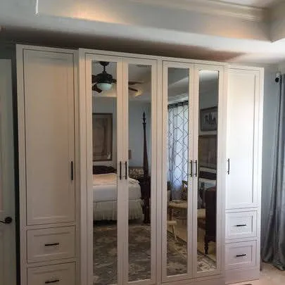 White mirrored closet doors with frame panels and side drawers