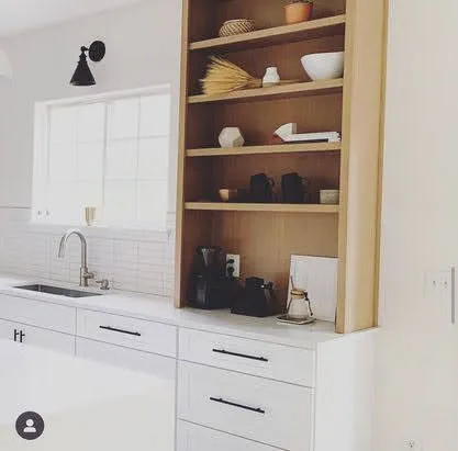 White shaker kitchen cabinetry with stained wood open shelving above