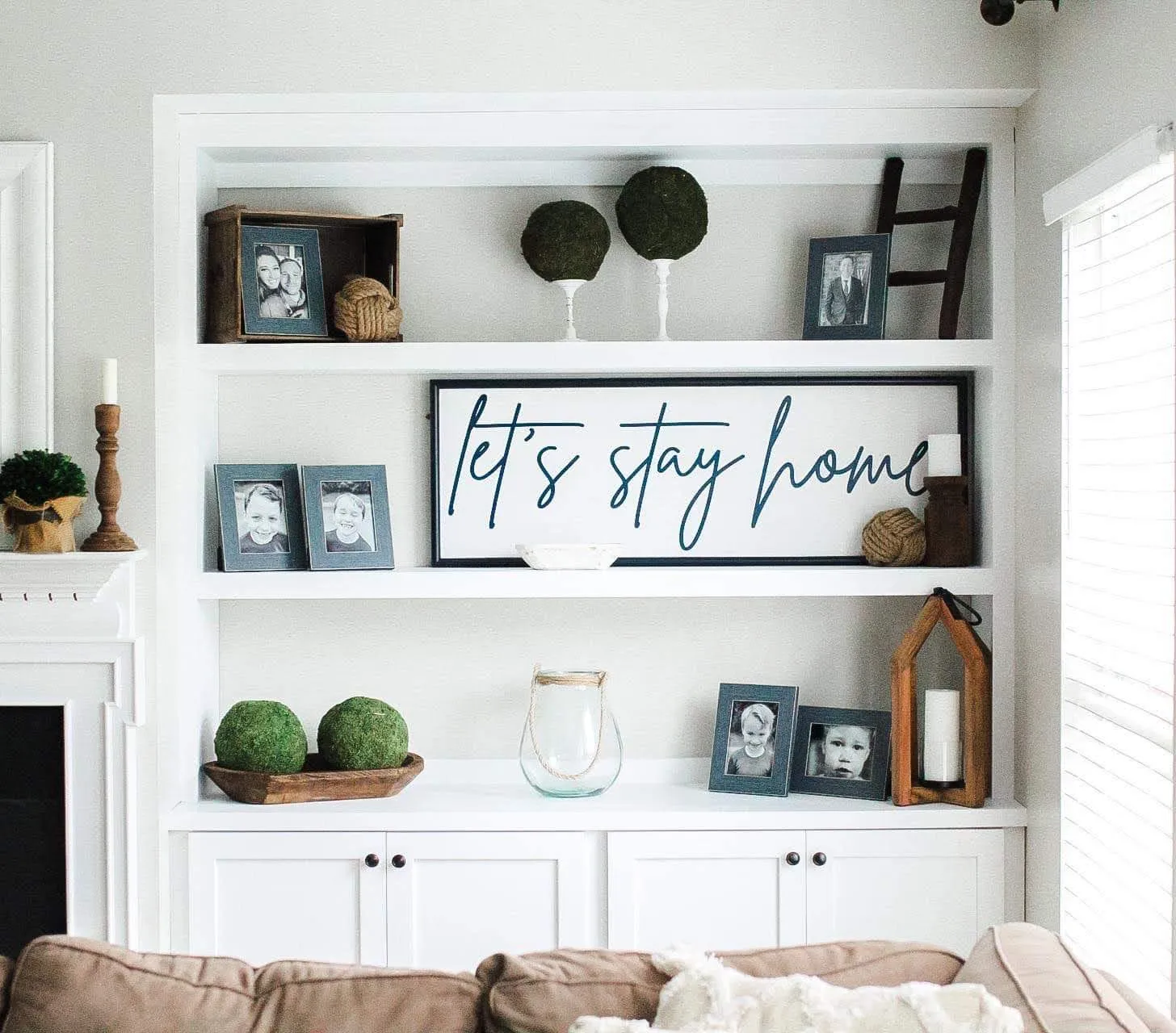 White living room shelving with open shelves and lower storage cabinet