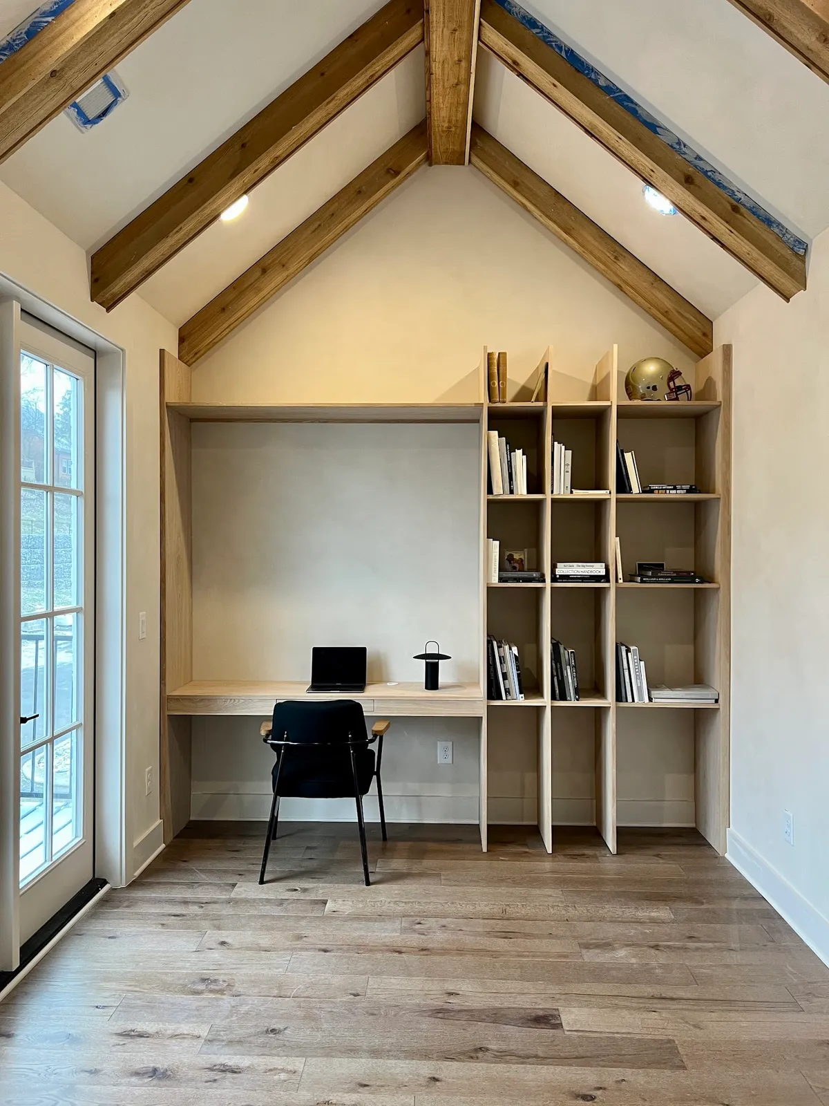 Home office nook with reclaimed wood beams and built-in desk cabinetry